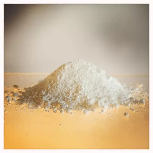 A heap of white granulated powder ready to be measured for the angle of repose.